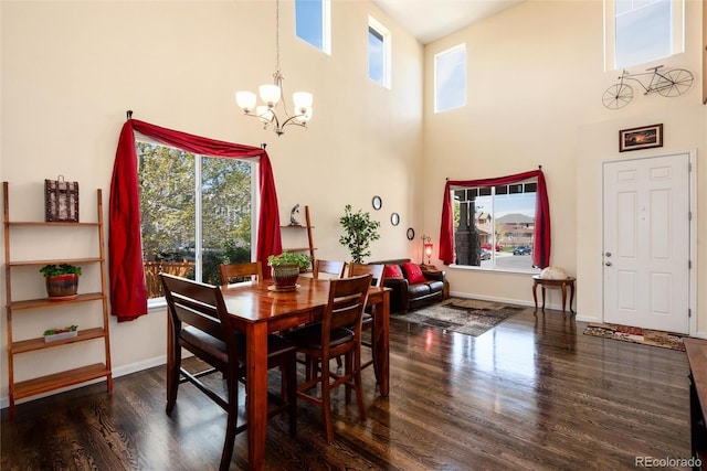 11460 W Tanforan Cir, Littleton, CO 80127 - dining room featuring a chandelier, a high ceiling, wood finished floors, plenty of natural light, and baseboards