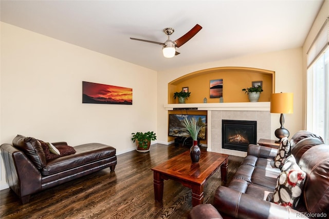 11460 W Tanforan Cir, Littleton, CO 80127 - living area featuring wood finished floors, a fireplace, ceiling fan, and baseboards