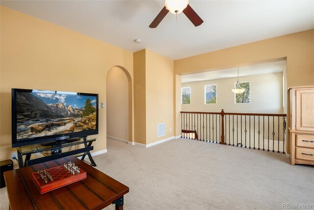 11460 W Tanforan Cir, Littleton, CO 80127 - sitting room with a ceiling fan, light carpet, baseboards, and arched walkways