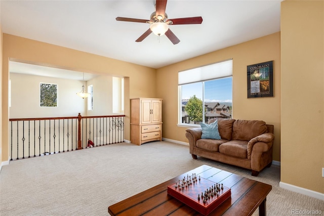 11460 W Tanforan Cir, Littleton, CO 80127 - carpeted living room featuring a ceiling fan, plenty of natural light, and baseboards