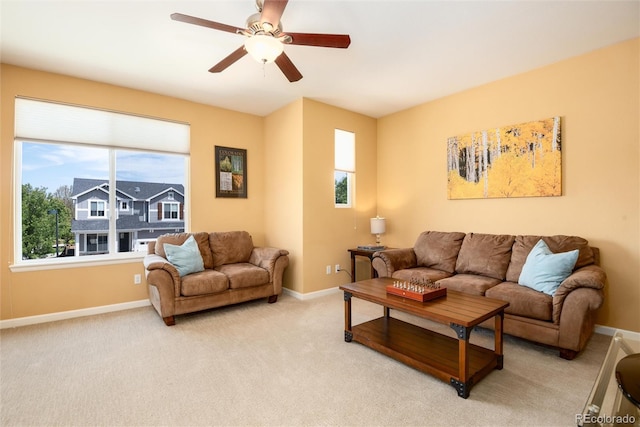 11460 W Tanforan Cir, Littleton, CO 80127 - living room featuring ceiling fan, baseboards, and light colored carpet