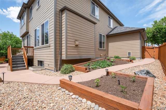 11460 W Tanforan Cir, Littleton, CO 80127 - view of home's exterior with a gate, fence, and a wooden deck
