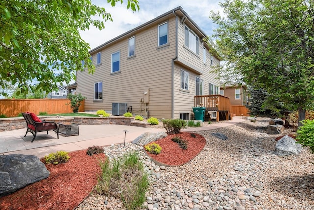 11460 W Tanforan Cir, Littleton, CO 80127 - rear view of property with central AC, fence, a patio area, and a wooden deck