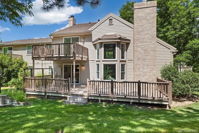 5922 E Briarwood Dr, Centennial, CO 80112 - rear view of property featuring a chimney, a balcony, a yard, and a deck
