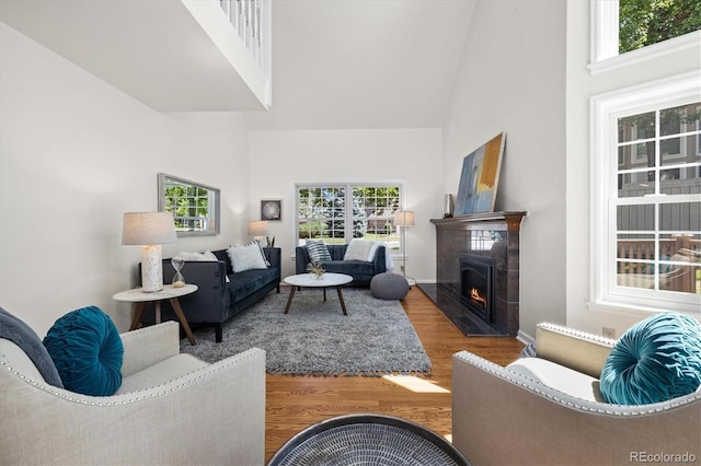 5922 E Briarwood Dr, Centennial, CO 80112 - living area featuring a high ceiling, wood finished floors, and a warm lit fireplace