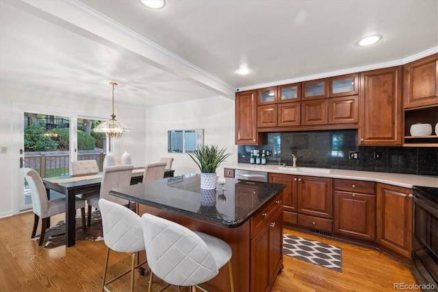5922 E Briarwood Dr, Centennial, CO 80112 - kitchen with light wood-style floors, a chandelier, range with electric stovetop, tasteful backsplash, and ornamental molding