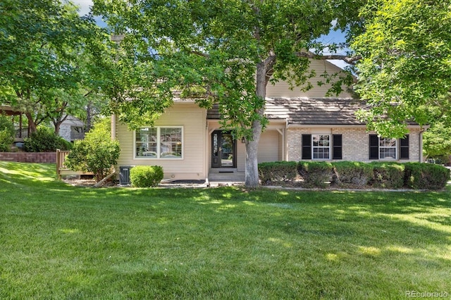 5922 E Briarwood Dr, Centennial, CO 80112 - view of property hidden behind natural elements featuring a front lawn and brick siding