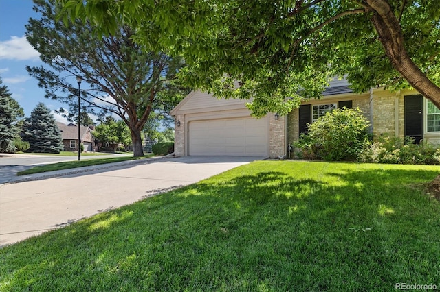 5922 E Briarwood Dr, Centennial, CO 80112 - obstructed view of property featuring brick siding, a garage, driveway, and a front yard