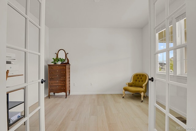 7325 S Waterloo Way, Aurora, CO 80016 - living area featuring light wood finished floors, french doors, and baseboards