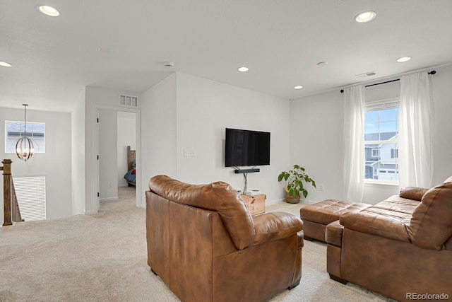 7325 S Waterloo Way, Aurora, CO 80016 - living area featuring a chandelier, recessed lighting, plenty of natural light, light colored carpet, and baseboards