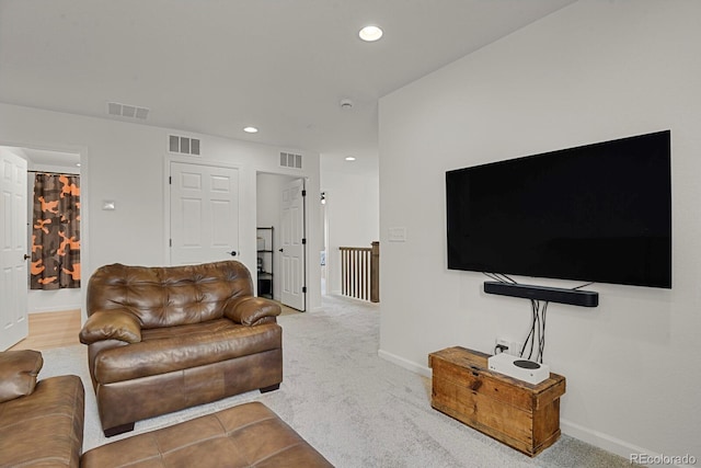 7325 S Waterloo Way, Aurora, CO 80016 - living room featuring recessed lighting, baseboards, and light colored carpet