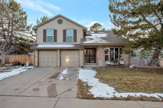 view of front of property featuring a garage and a lawn