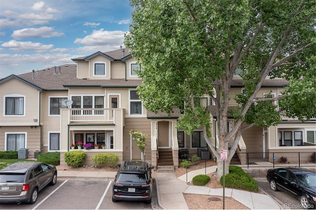 8707 E Florida Ave Unit 614, Denver, CO 80247 - multi unit property with uncovered parking, a shingled roof, and central AC