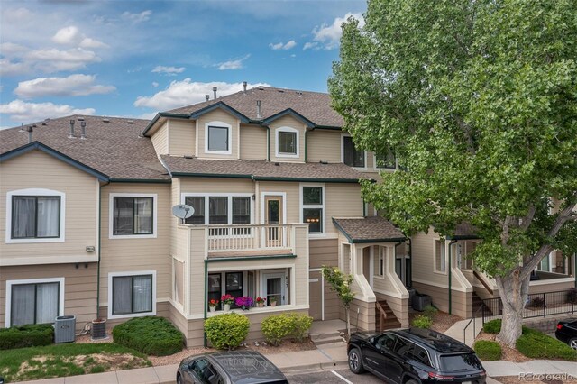 8707 E Florida Ave Unit 614, Denver, CO 80247 - view of building exterior featuring central AC unit and uncovered parking