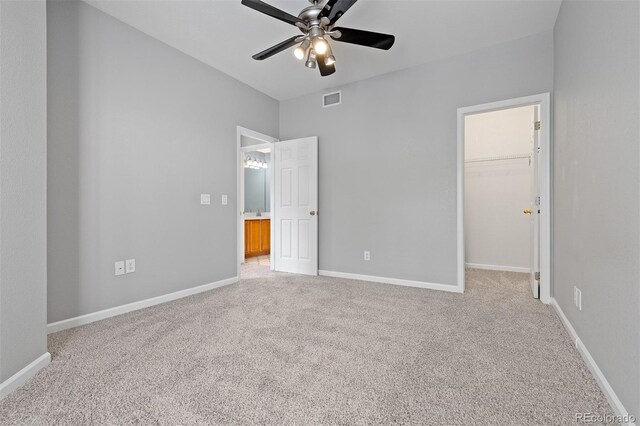 8707 E Florida Ave Unit 614, Denver, CO 80247 - unfurnished bedroom featuring light colored carpet, a spacious closet, baseboards, and a closet