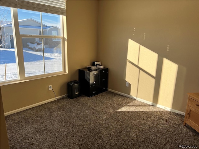 unfurnished room featuring plenty of natural light and carpet