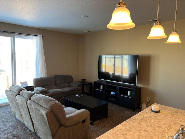 living room featuring a textured ceiling and dark carpet