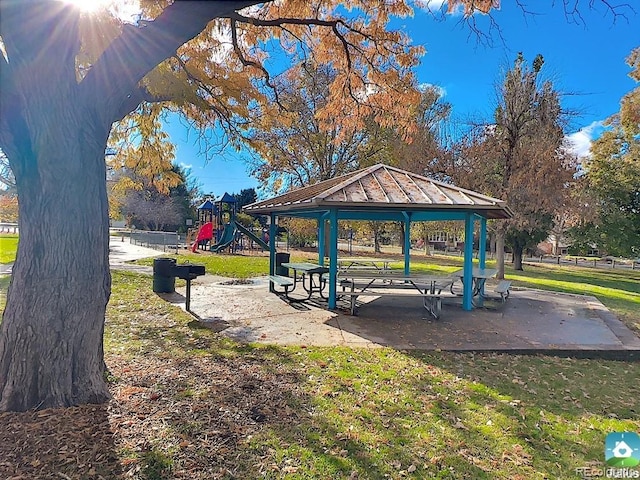 view of property's community with a lawn, a gazebo, and a playground