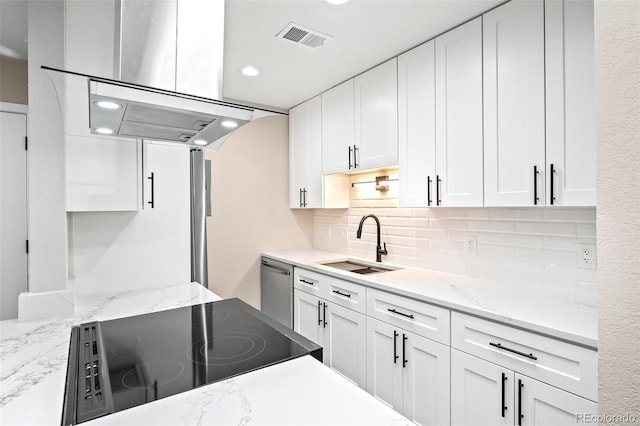 kitchen featuring stainless steel dishwasher, stove, white cabinetry, and sink