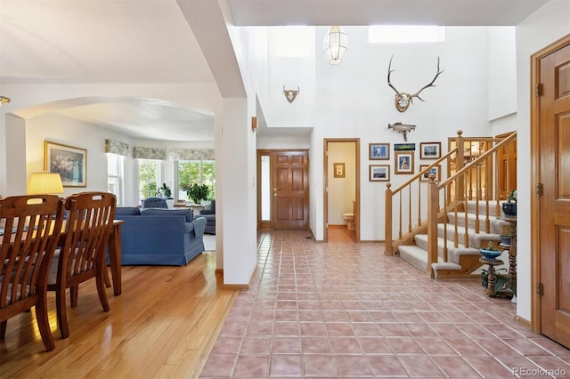 12963 W 84th Pl, Arvada, CO 80005 - foyer entrance with arched walkways, stairway, and a high ceiling