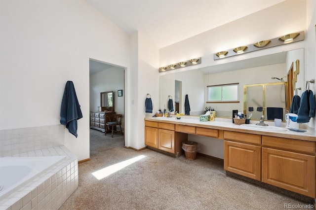 12963 W 84th Pl, Arvada, CO 80005 - bathroom featuring double vanity, a stall shower, a bath, carpet flooring, and vaulted ceiling