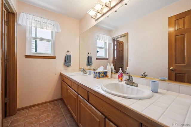 12963 W 84th Pl, Arvada, CO 80005 - full bathroom featuring double vanity, healthy amount of natural light, and tile patterned flooring