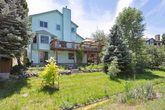 12963 W 84th Pl, Arvada, CO 80005 - rear view of property with a wooden deck and a chimney