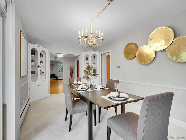 5895 W Plymouth Dr, Littleton, CO 80128 - dining space with a baseboard radiator and a chandelier