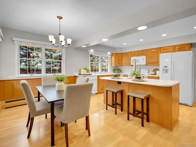 5895 W Plymouth Dr, Littleton, CO 80128 - dining area featuring a chandelier, light wood-type flooring, recessed lighting, and a baseboard radiator