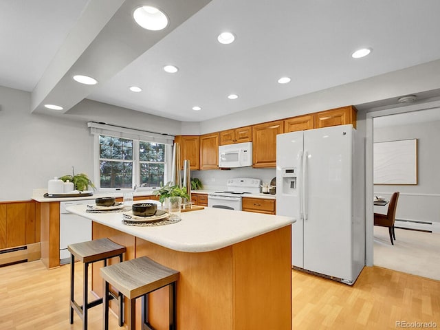 5895 W Plymouth Dr, Littleton, CO 80128 - kitchen with white appliances, light countertops, recessed lighting, a baseboard heating unit, and light wood finished floors