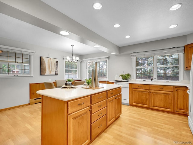 5895 W Plymouth Dr, Littleton, CO 80128 - kitchen with white dishwasher, light wood finished floors, light countertops, and recessed lighting