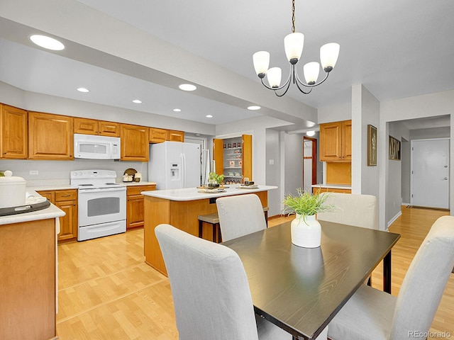 5895 W Plymouth Dr, Littleton, CO 80128 - dining room featuring light wood-type flooring, a chandelier, and recessed lighting