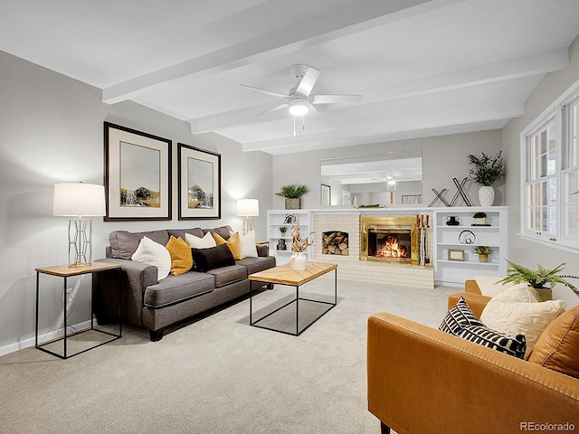 5895 W Plymouth Dr, Littleton, CO 80128 - living room featuring carpet floors, beam ceiling, a ceiling fan, and a brick fireplace