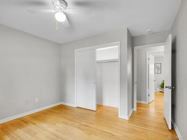 5895 W Plymouth Dr, Littleton, CO 80128 - unfurnished bedroom with light wood-style flooring, a closet, and a ceiling fan