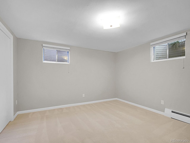 5895 W Plymouth Dr, Littleton, CO 80128 - basement with light colored carpet and a baseboard heating unit