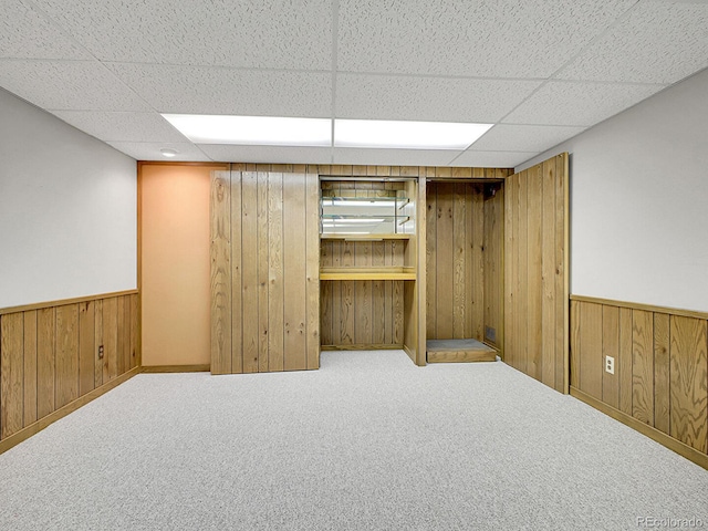 5895 W Plymouth Dr, Littleton, CO 80128 - finished basement featuring wooden walls, a wainscoted wall, a paneled ceiling, and carpet flooring