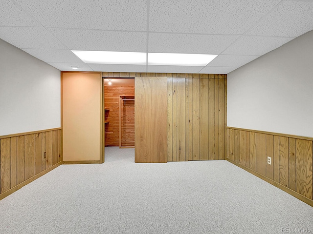 5895 W Plymouth Dr, Littleton, CO 80128 - finished basement with wooden walls, wainscoting, a paneled ceiling, and carpet