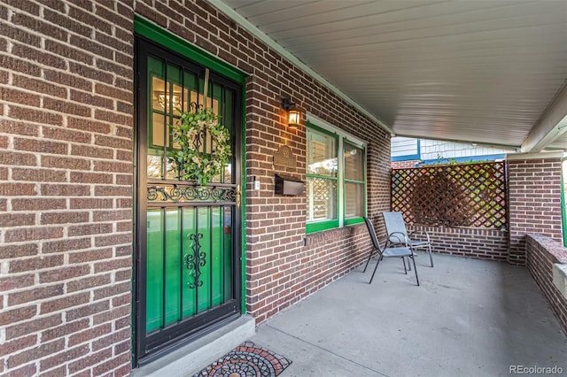 view of exterior entry with covered porch