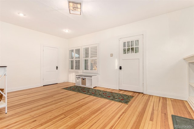 foyer entrance with light hardwood / wood-style floors