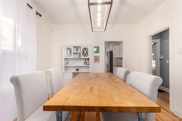 dining space with light hardwood / wood-style flooring