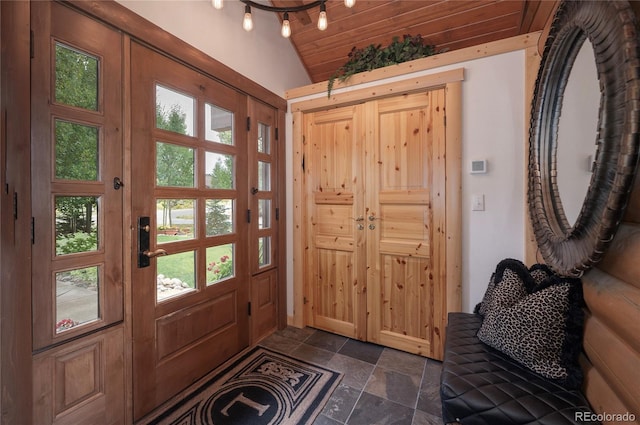 entryway with plenty of natural light, vaulted ceiling, and wooden ceiling