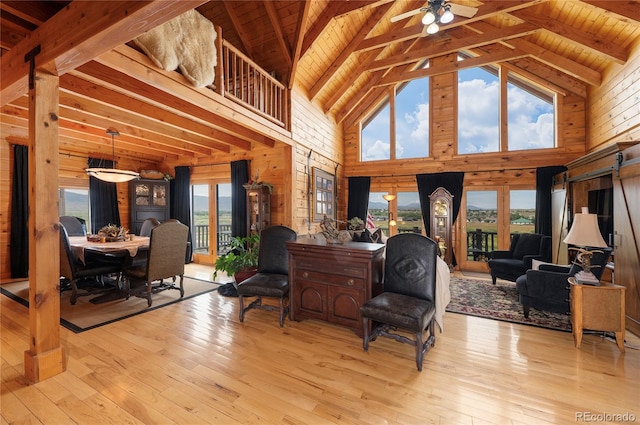 sitting room featuring light wood-type flooring, high vaulted ceiling, and plenty of natural light