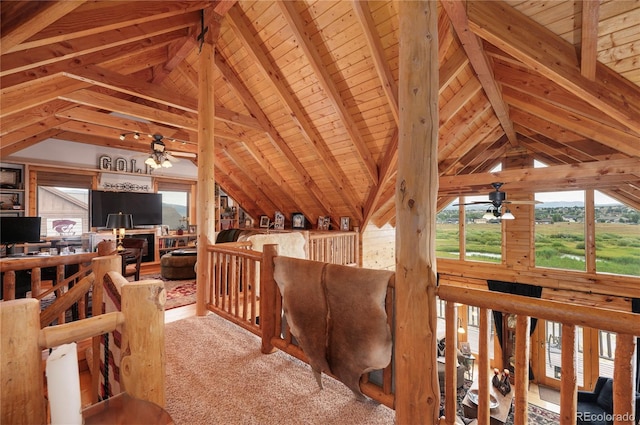 interior space featuring vaulted ceiling with beams, multiple windows, and wood ceiling