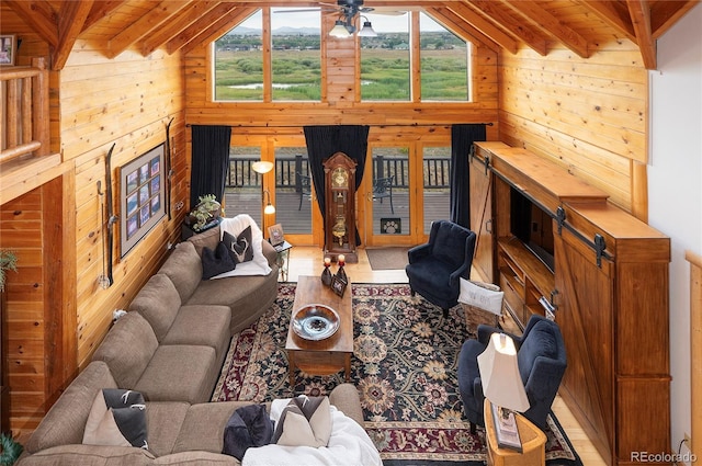 living room featuring plenty of natural light, wooden walls, and hardwood / wood-style floors