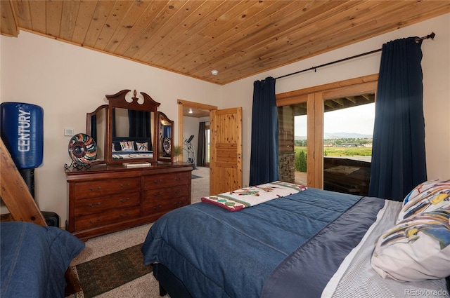 bedroom featuring wood ceiling, access to exterior, and carpet floors