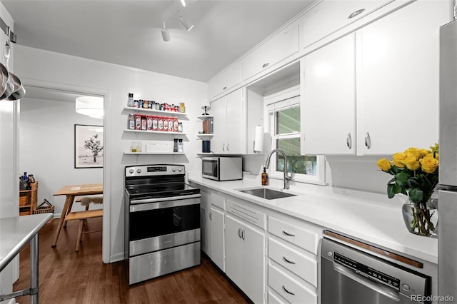 3231 S Elati St, Englewood, CO 80110 - kitchen with stainless steel appliances, a sink, dark wood-style floors, and white cabinets