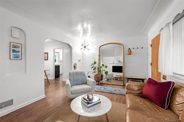 3231 S Elati St, Englewood, CO 80110 - living room with arched walkways, wood finished floors, and baseboards