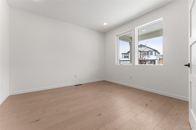 unfurnished room with light hardwood / wood-style floors