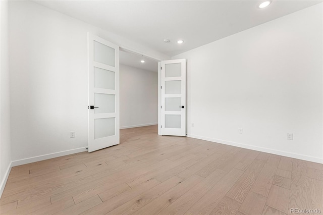 unfurnished bedroom with french doors and light hardwood / wood-style flooring