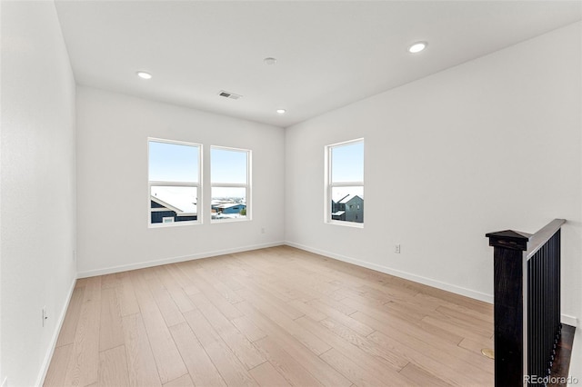 spare room with light hardwood / wood-style floors